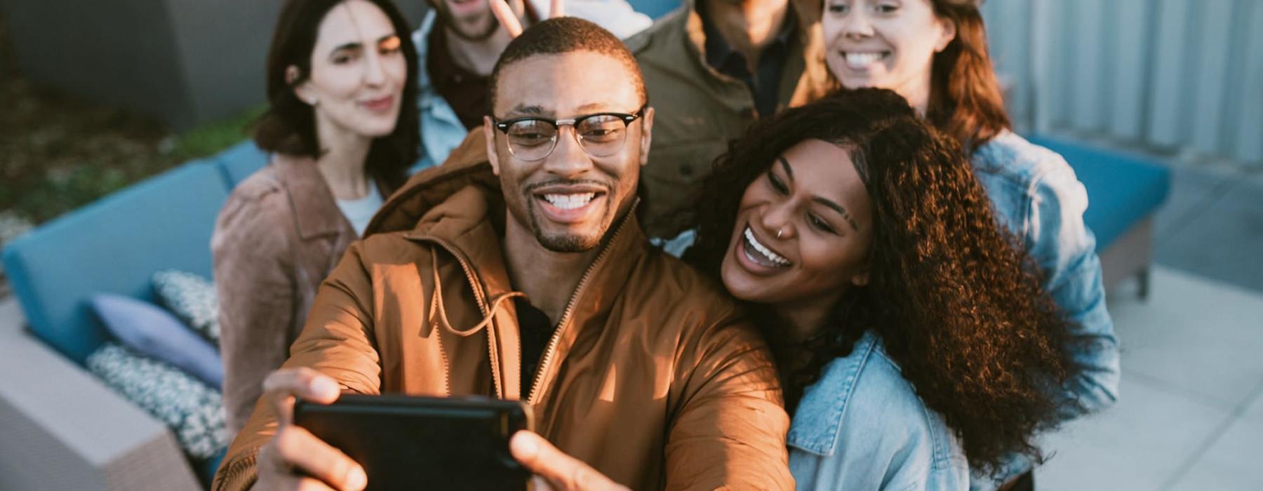 friends take a group selfie outdoors